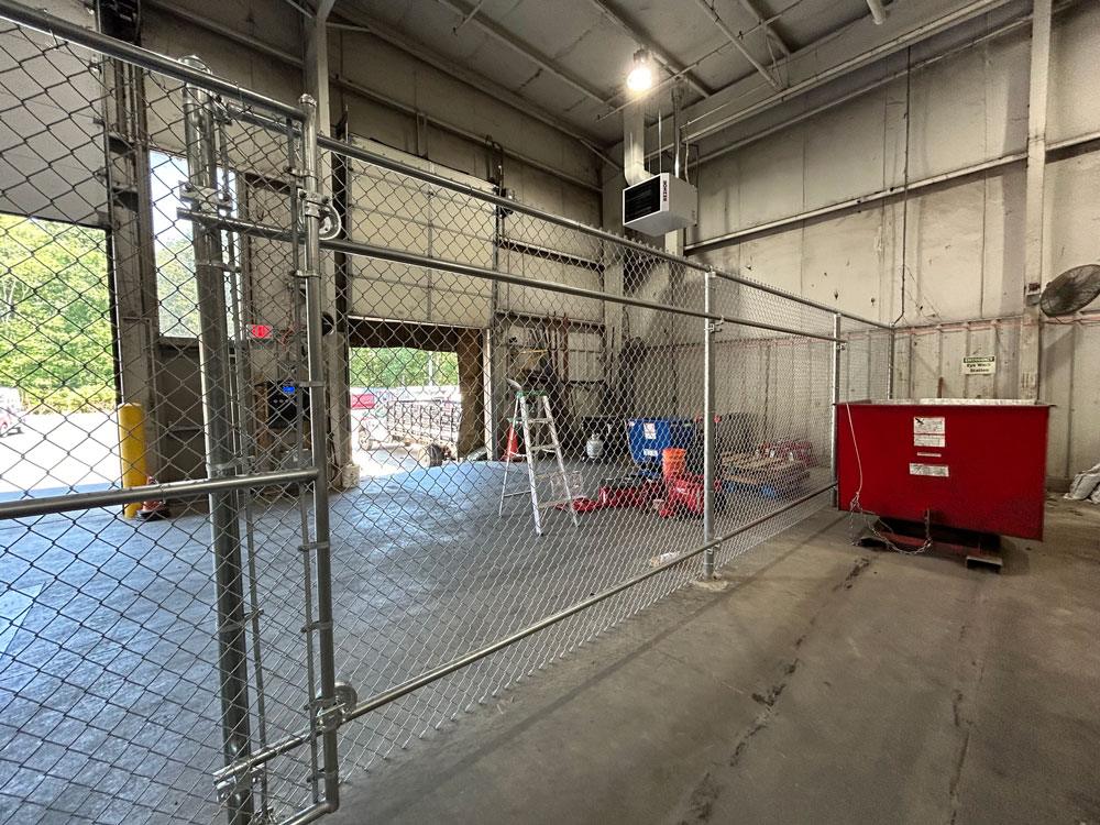 A commercial security chain link fence used inside a warehouse.