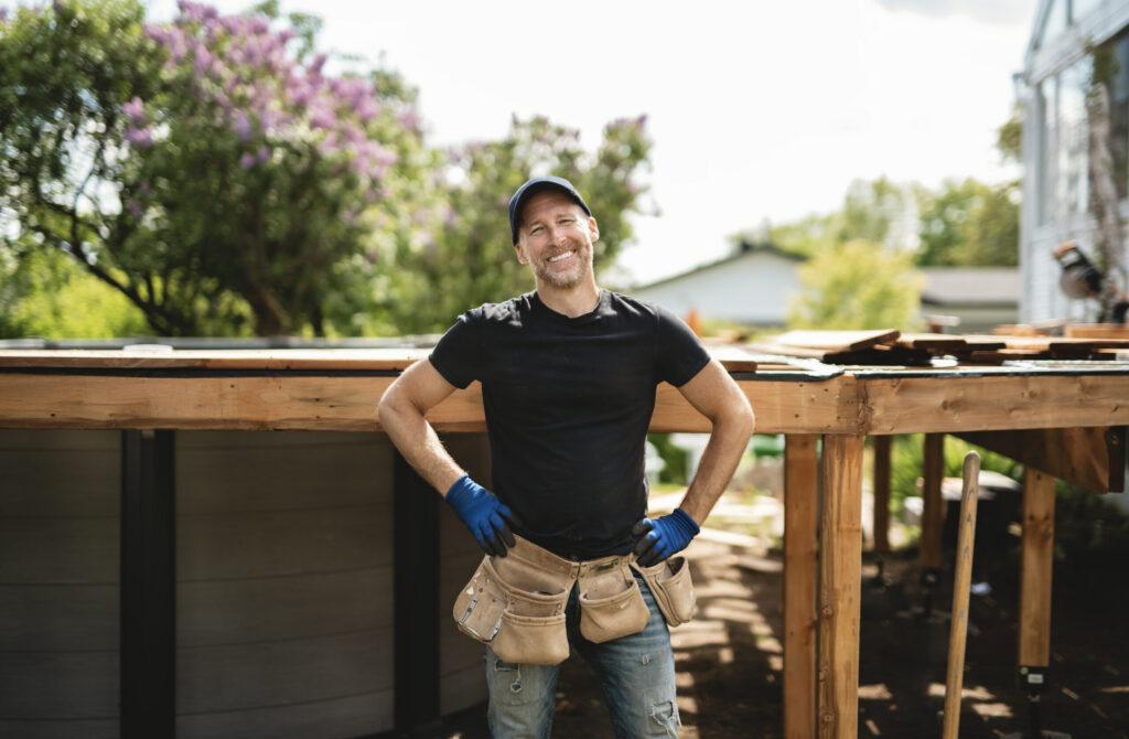 Handyman worker making patio outside close to a pool