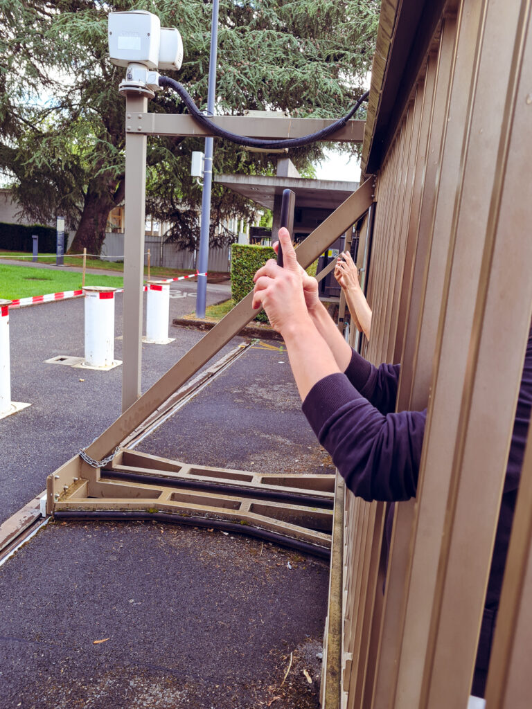 People filming through the fence.