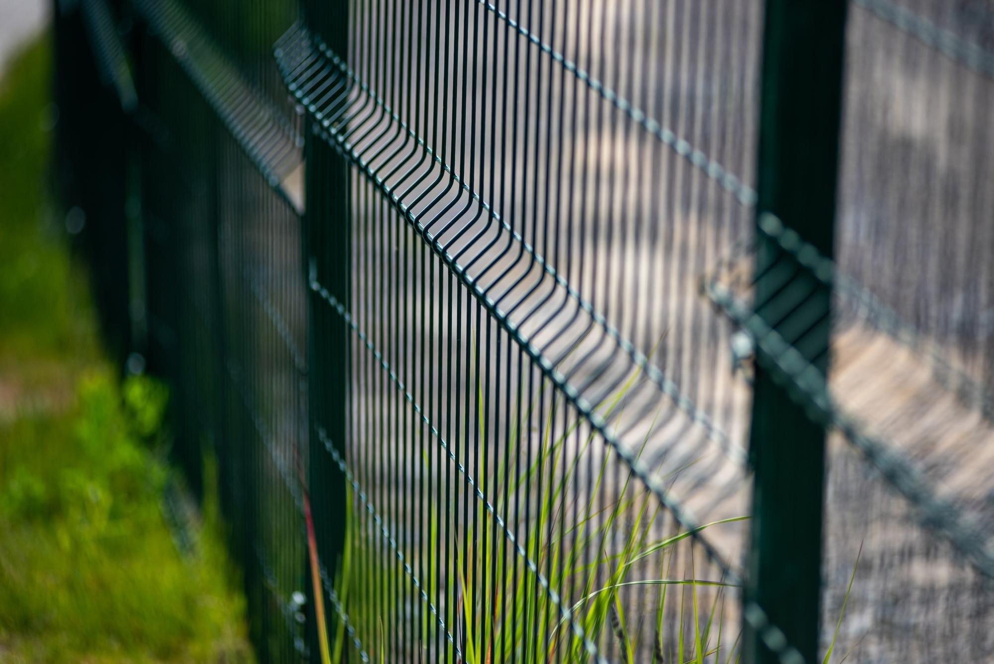 A Fence With A Green Fence That Has A Fence Around