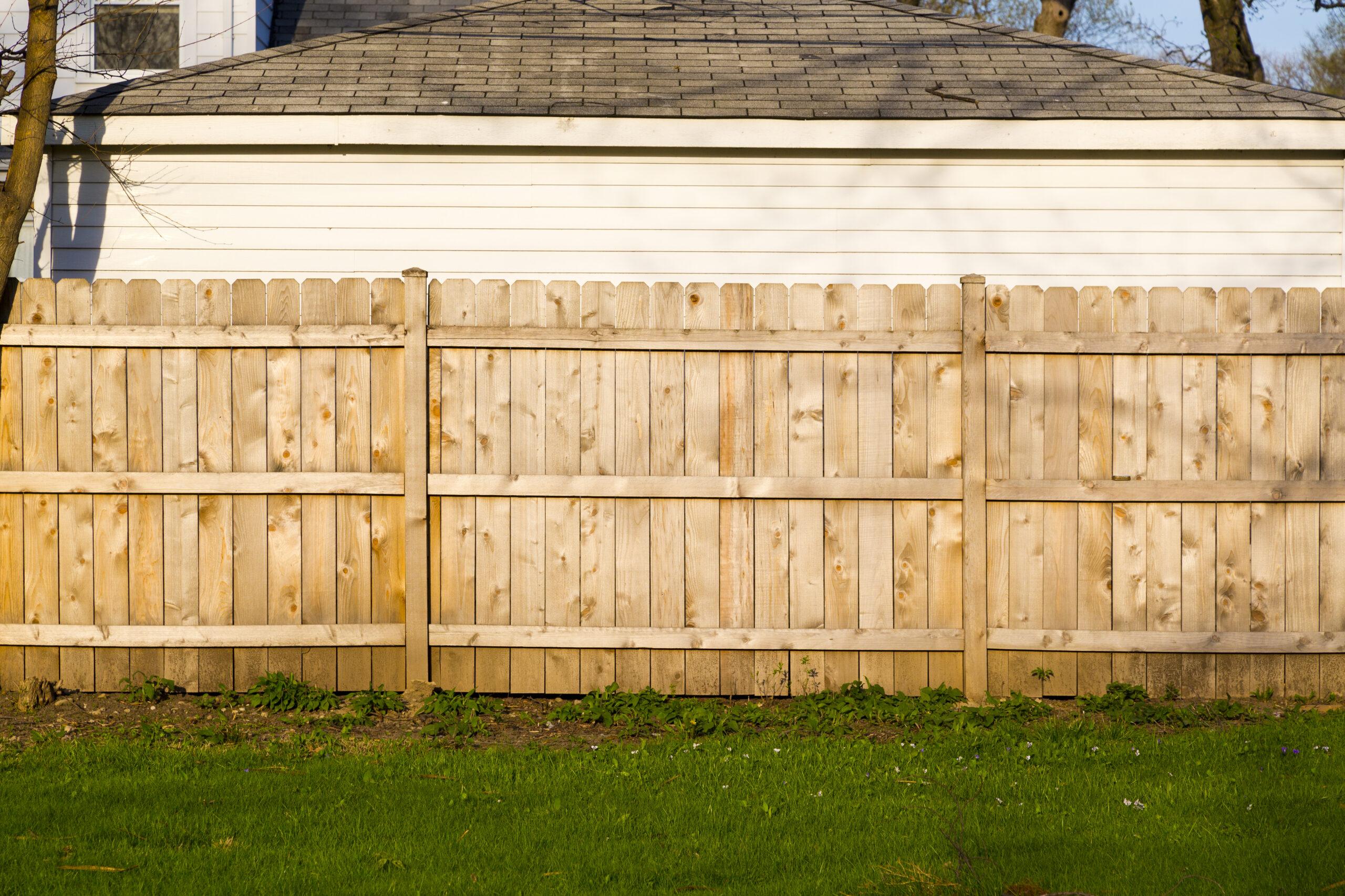 A Hard Wood Fence Outside A House