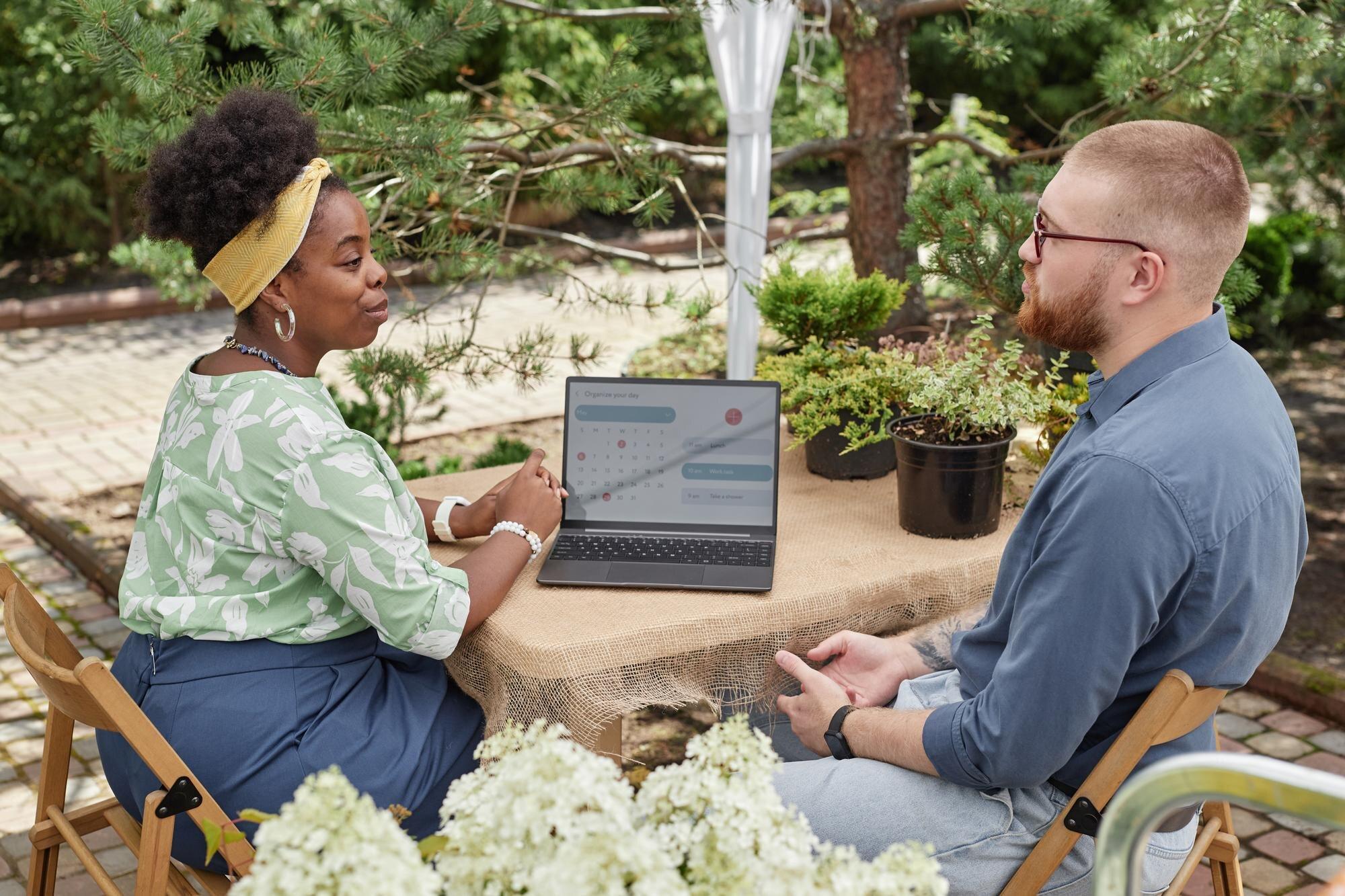 Black Female Landscape Designer At Table With Lapt