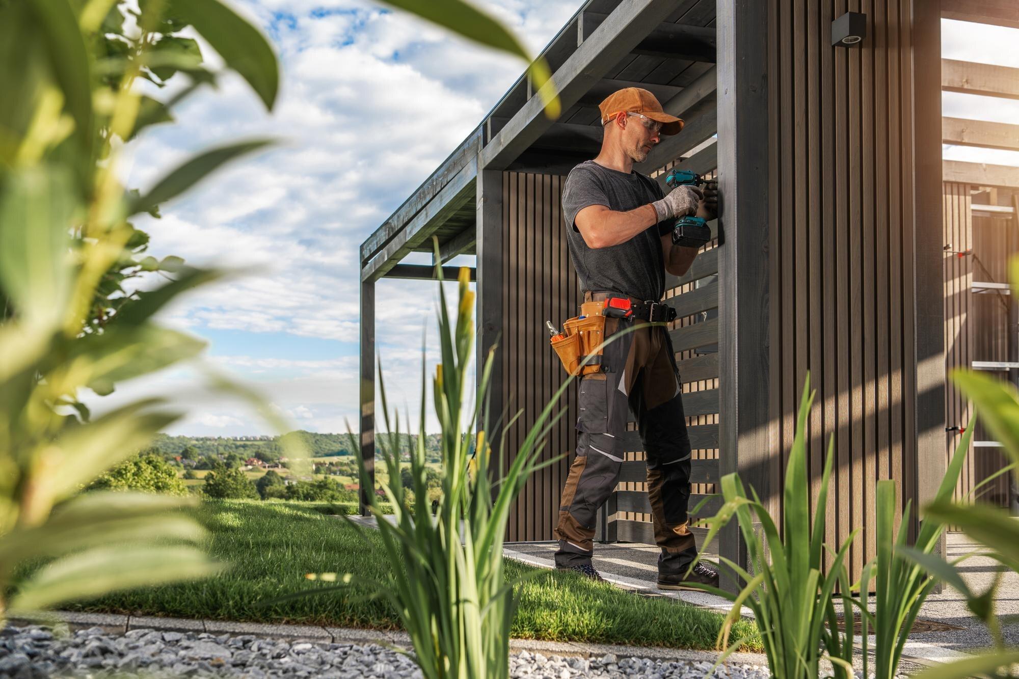 Construction Worker Installing Features On Modern
