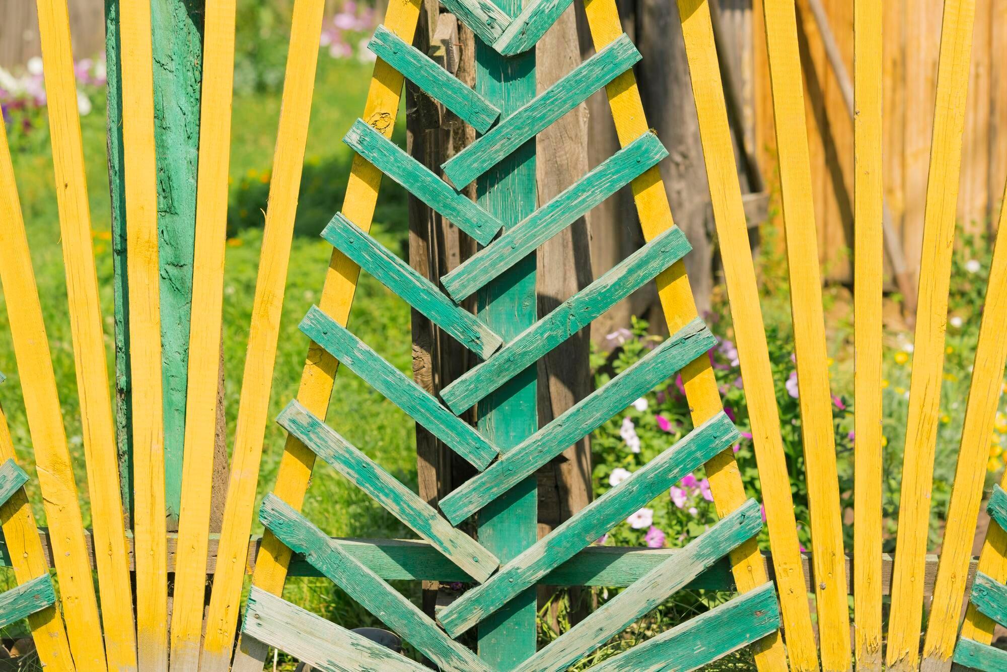 Green And Yellow Fence Of Wooden Planks