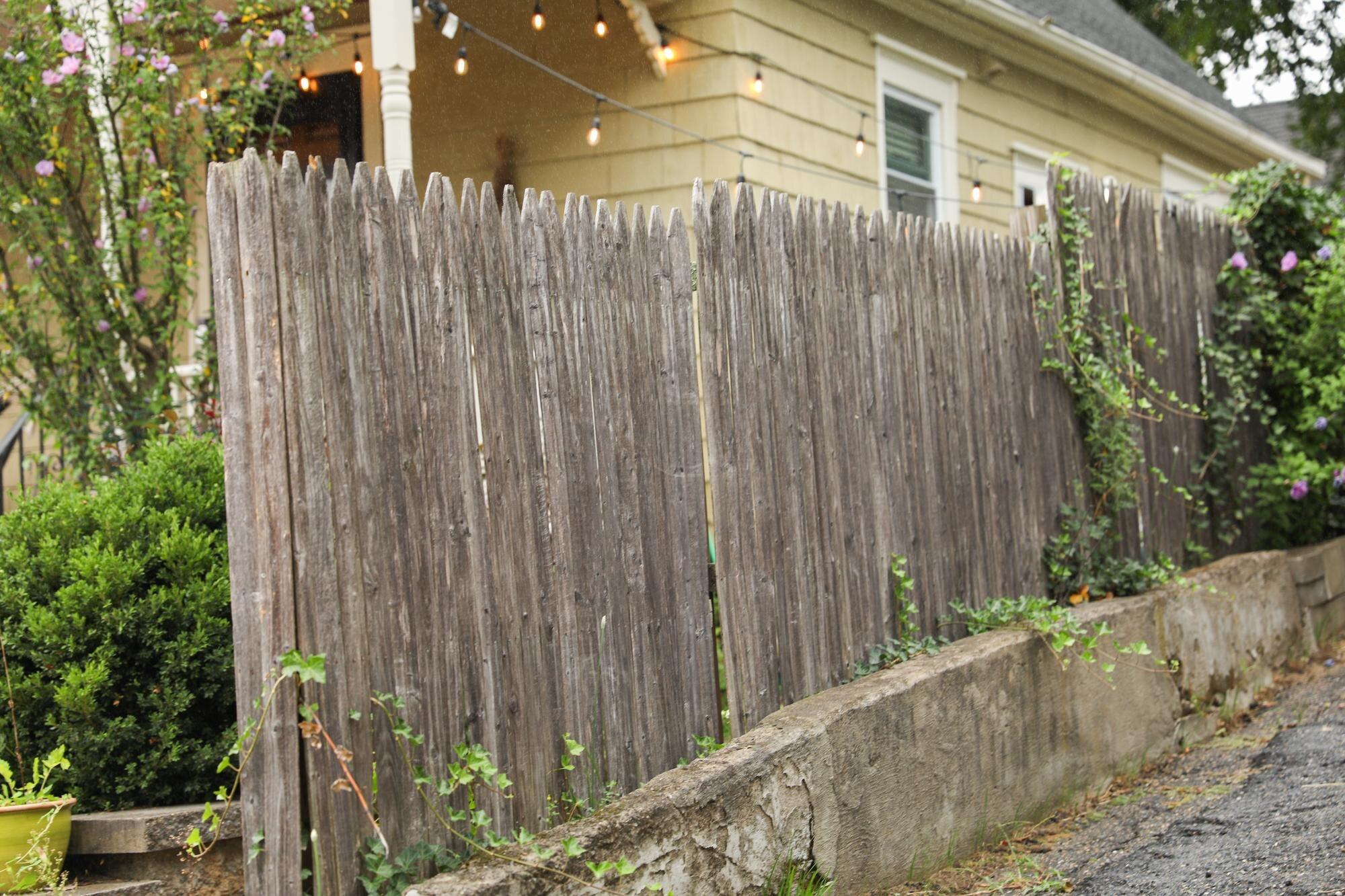 Rustic Wooden Fence Nestled Among Wildflowers Evok