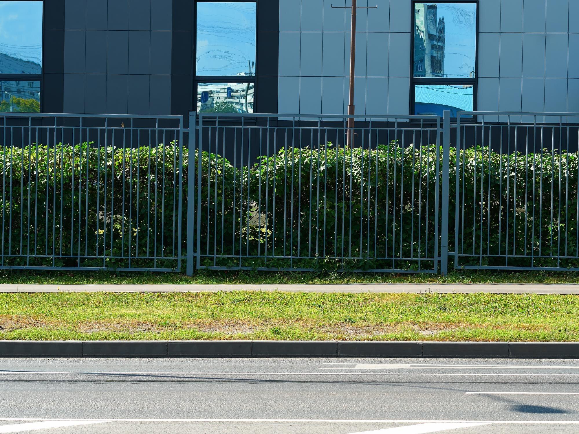 Strict Office Fence On Summer Street Background