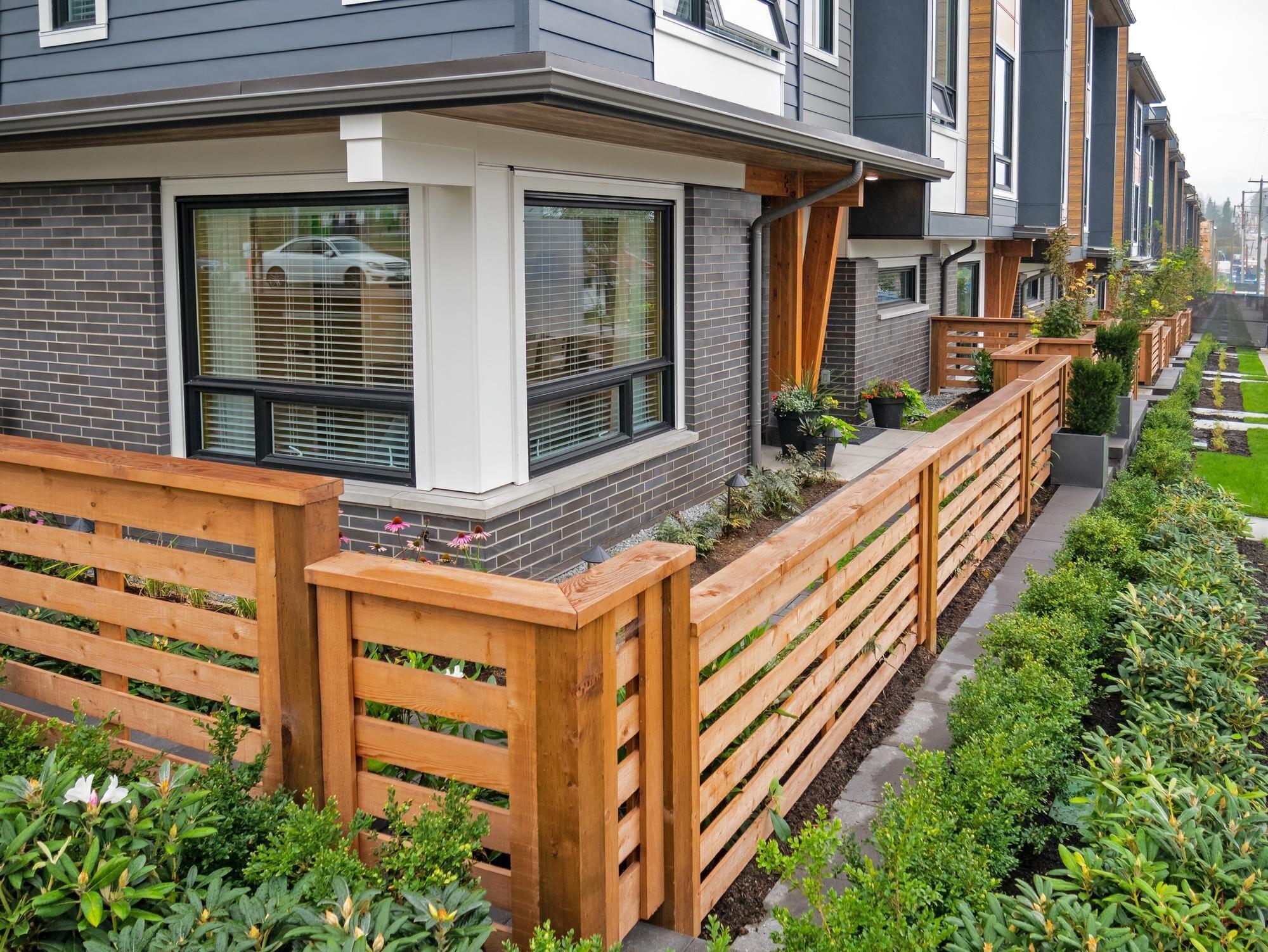 Wooden Fence In Front Of New Residential Townhouse