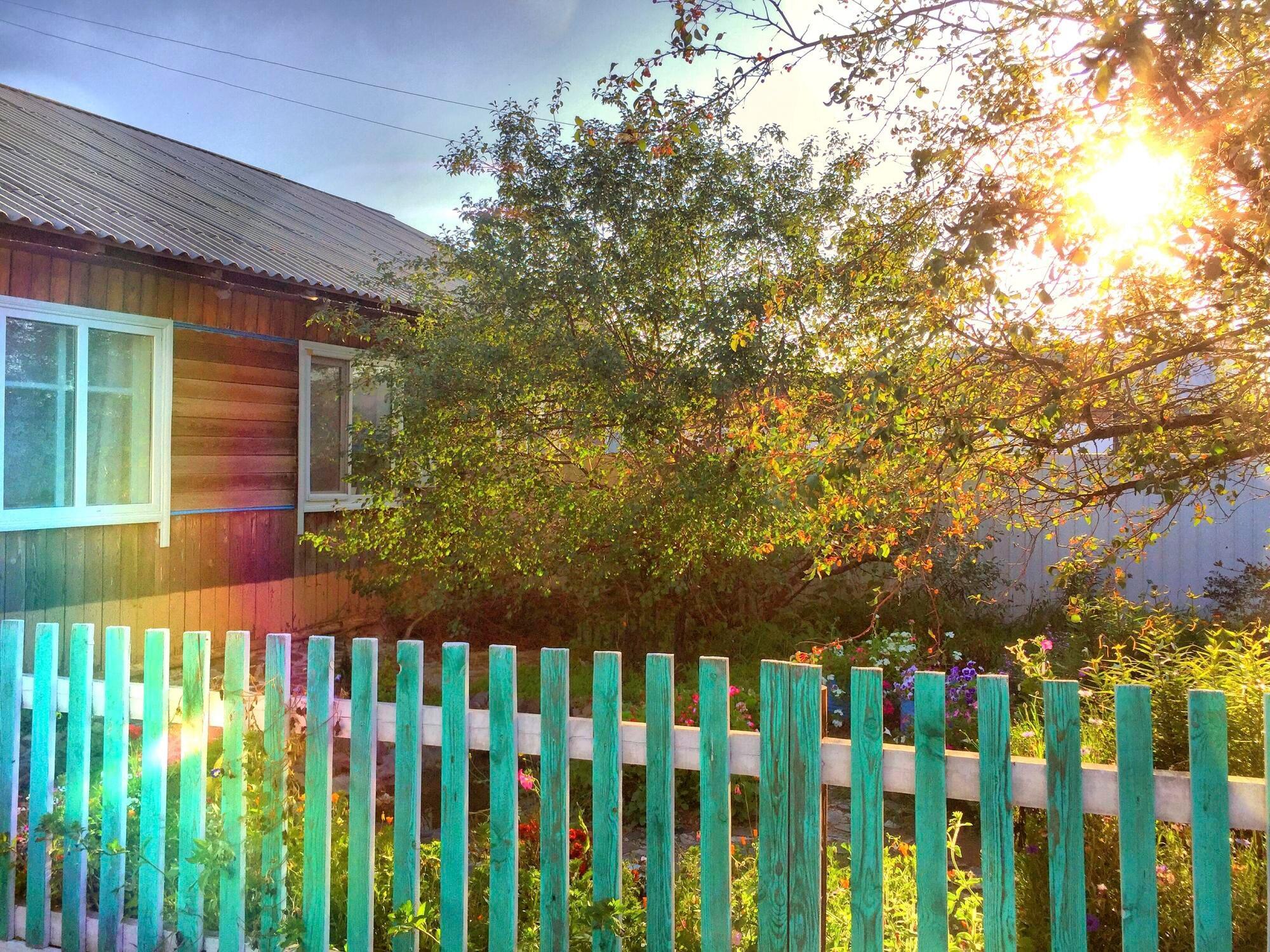 Wooden House In The Village In The Rays Of The Set