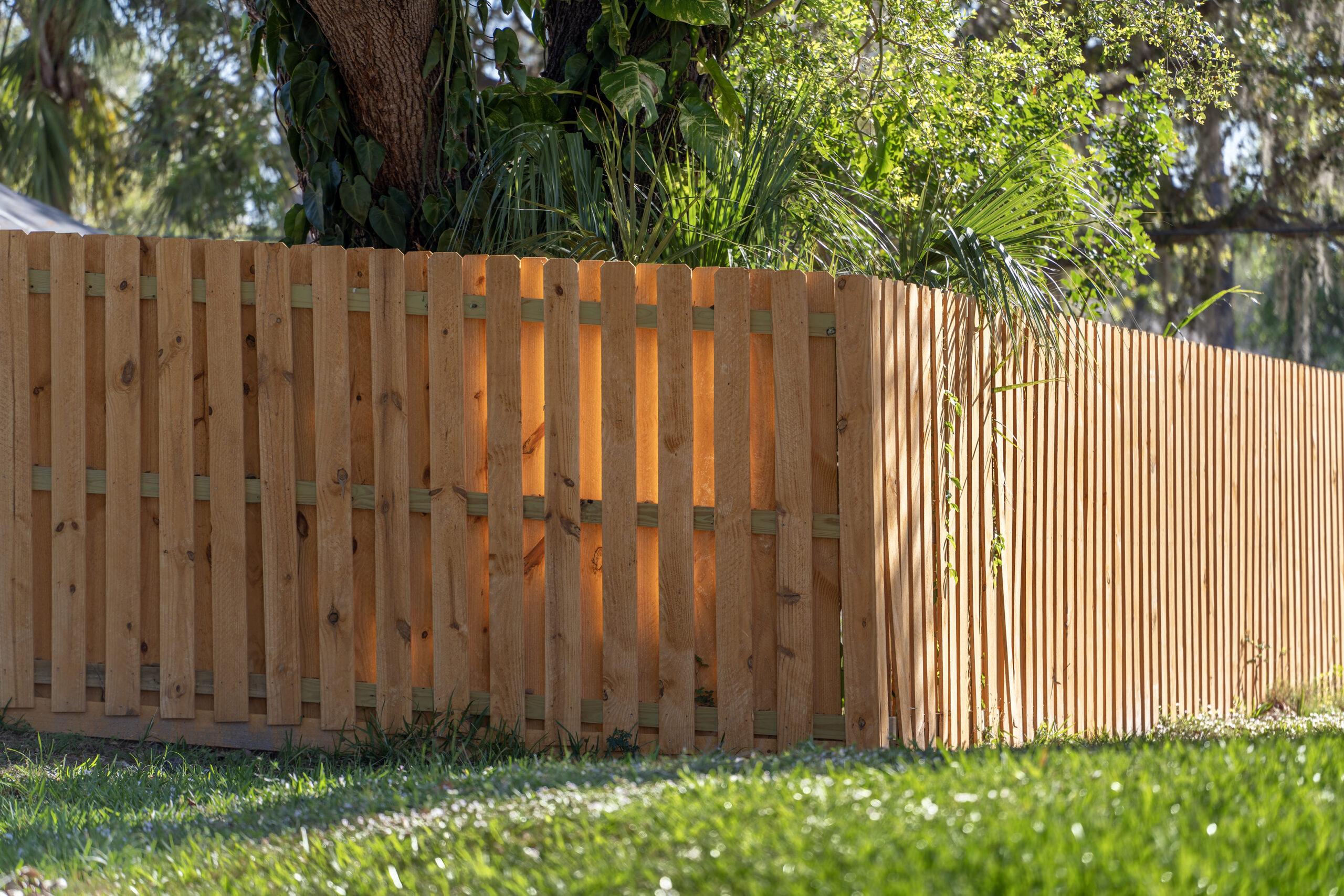 Wooden Picket Fence On Green Lawn Surrounding Prop